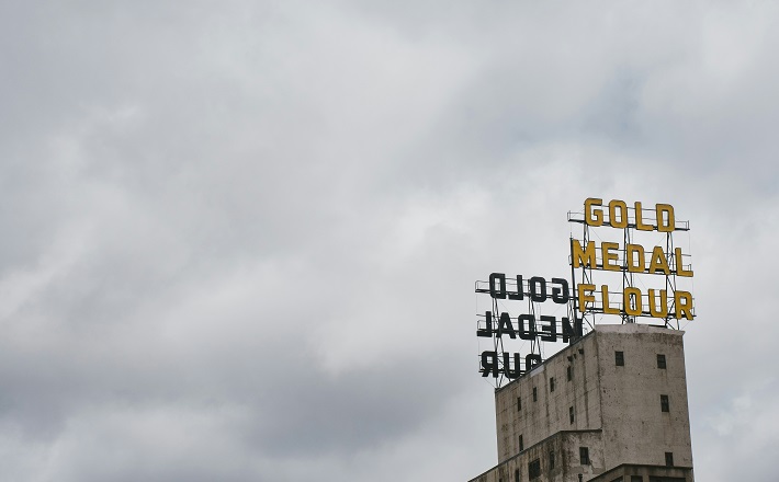 Gold Medal Flour sign against a cloudy sky in Minneapolis.