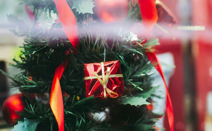 Advent preaching in a consumerist culture - photo of Christmas tree with red glitzy baubles
