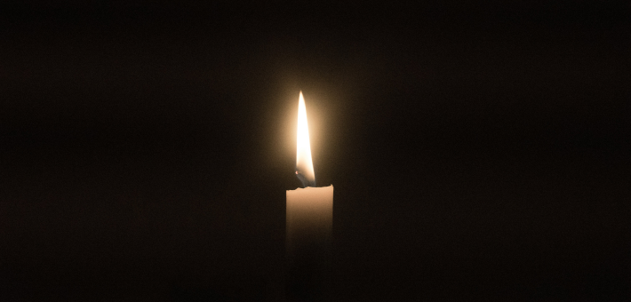 Photo of candle light in the darkness