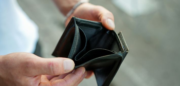 Man holding empty wallet