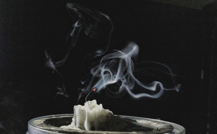 candle smoke and glowing wick after being extinguished