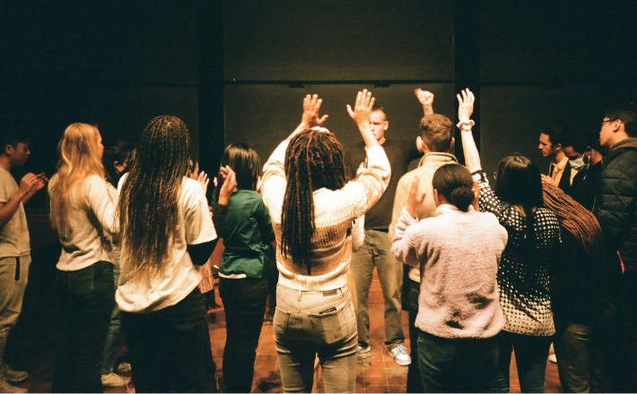 photo of a racially diverse group worshipping/praying together