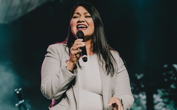 Woman delivering authentic preaching with wireless mic