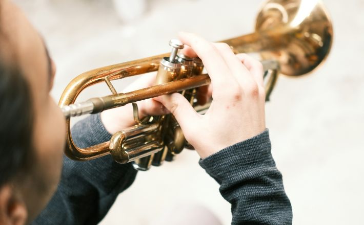 Young woman playing trumpet