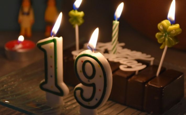 birthday cake with 19 candles lit