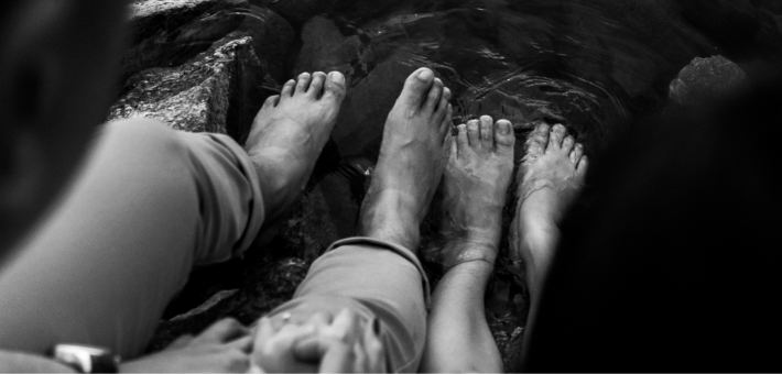 black and white photo of feet washing