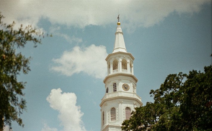 White and brown concrete building under a blue sky during daytime