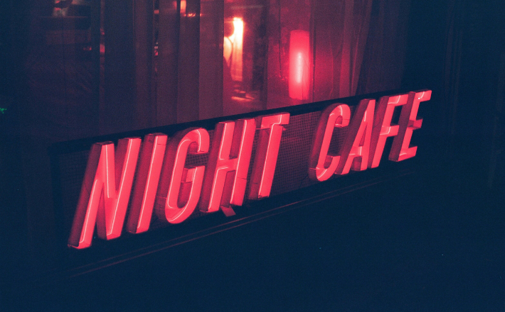 Red neon sign for night cafe at night.