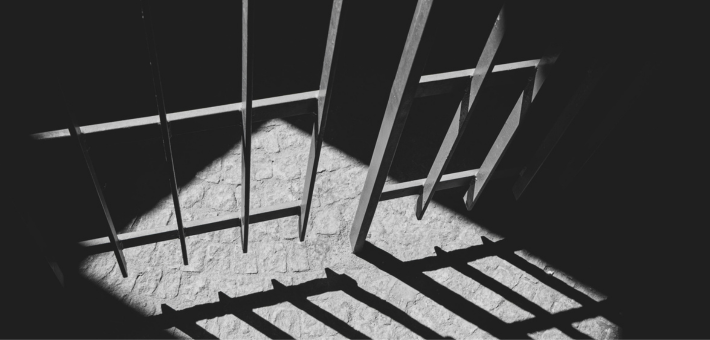 black and white photo of prison bars
