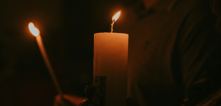 photo of a candle lit at a church vigil
