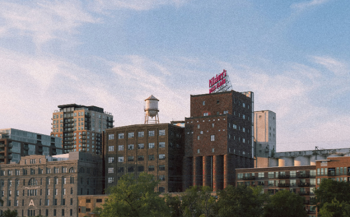 A city skyline with buildings and a water tower.