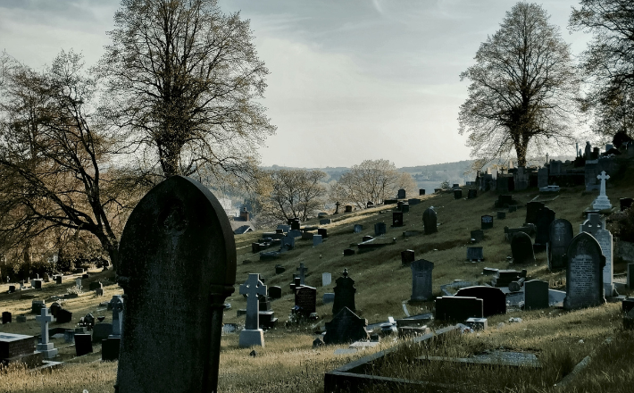 A cemetery with many tombstones.