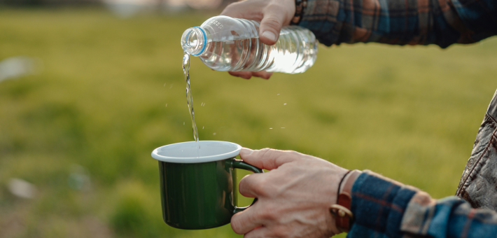 photo of someone pouring water into a mug