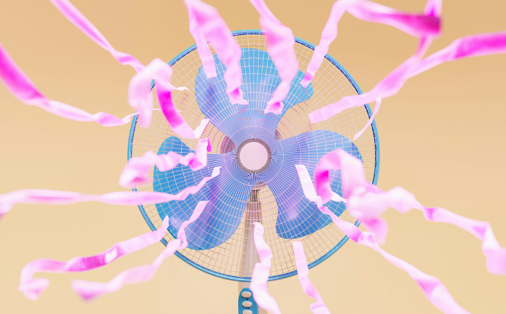 Front view of a blue fan with pink ribbons fluttering.