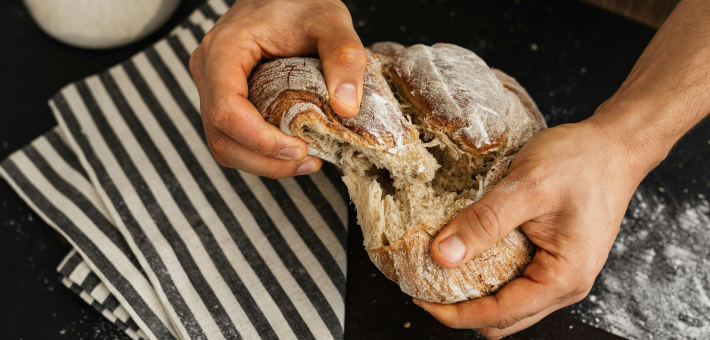 photo of hands breaking bread