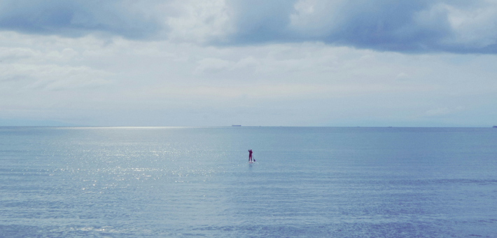 photo of a lone person at sea